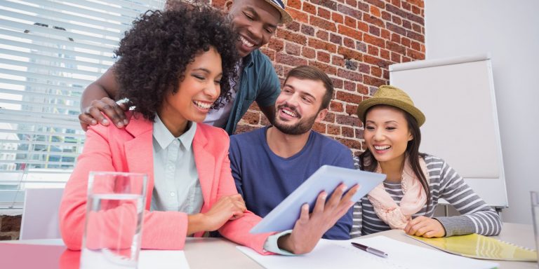 Creative business team using digital tablet in meeting at office