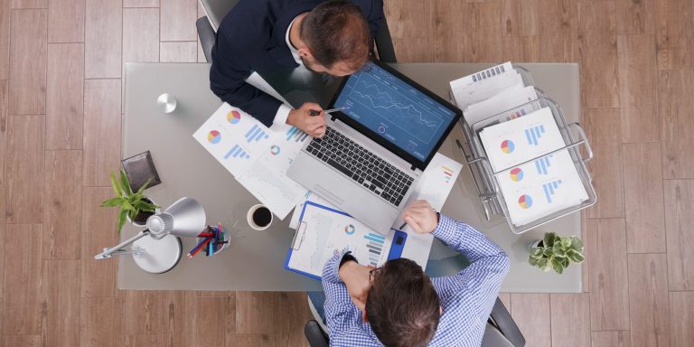 Top view of businessman showing management strategy presentation to partner