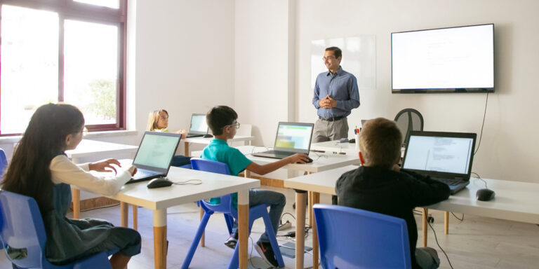 Confident teacher explaining lesson to pupils